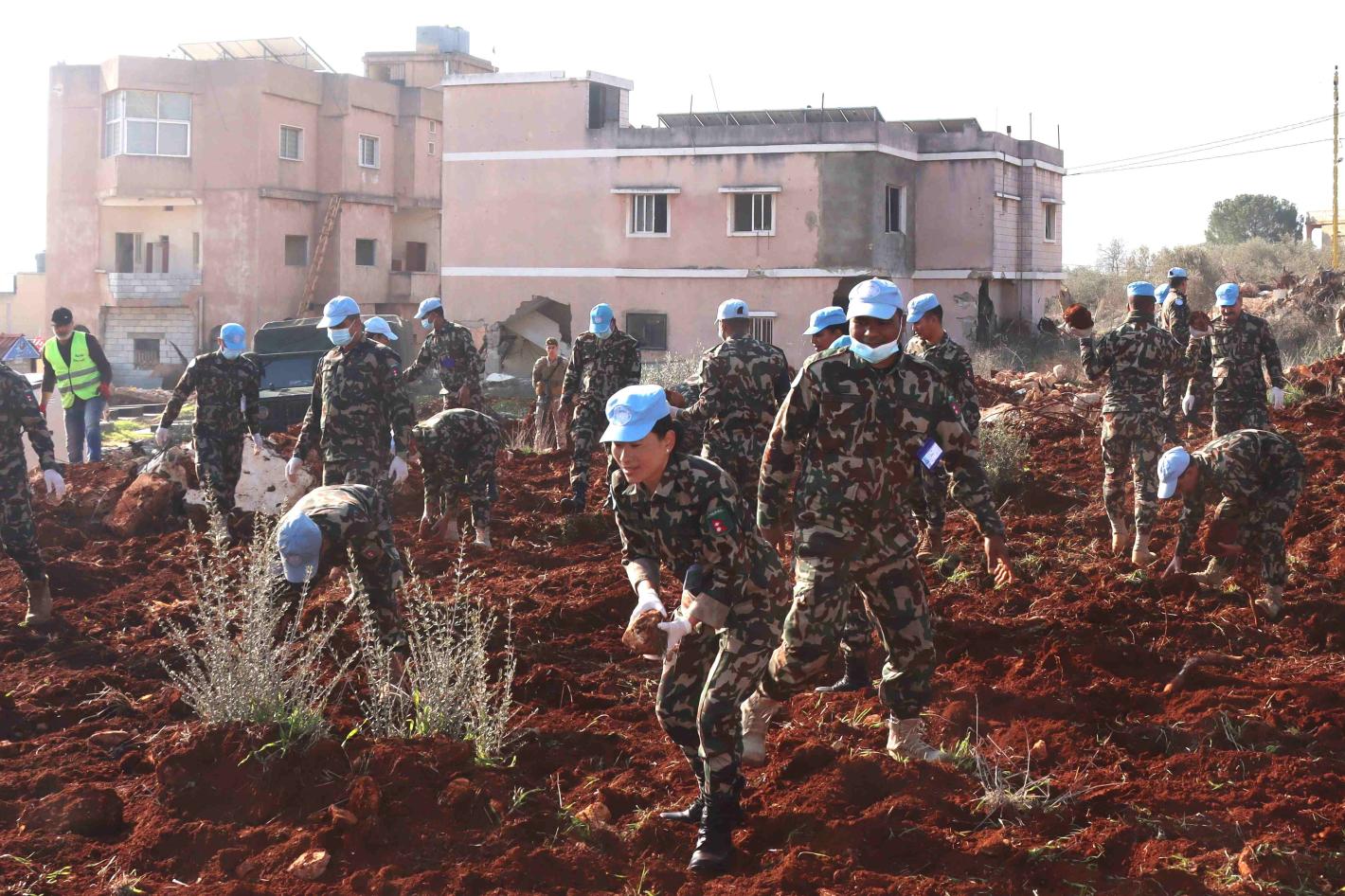 Peacekeepers assist Blida residents to prepare field for olive plantation