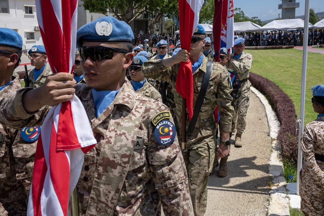 Peacekeepers march outside.
