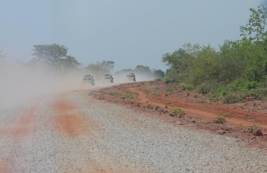 A UN vehicle is parked in front of a building with a blue door and white walls.